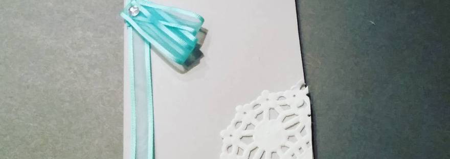 Handmade basic wedding card with blue ribbon and paper doilie accents