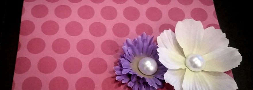 Handmade mothers day card on pink patterned cardstock and two silk flowers