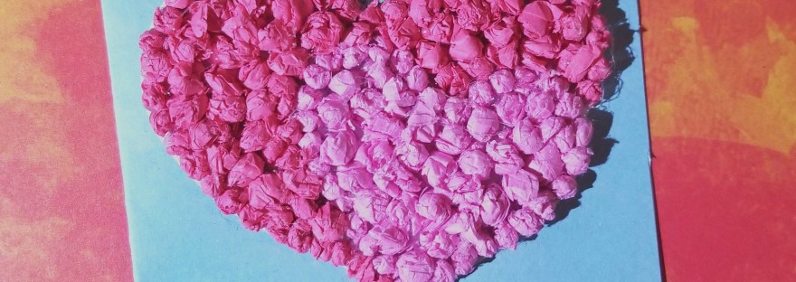 Handmade card of valentines hearts made of pink tissue paper on blue cardstock